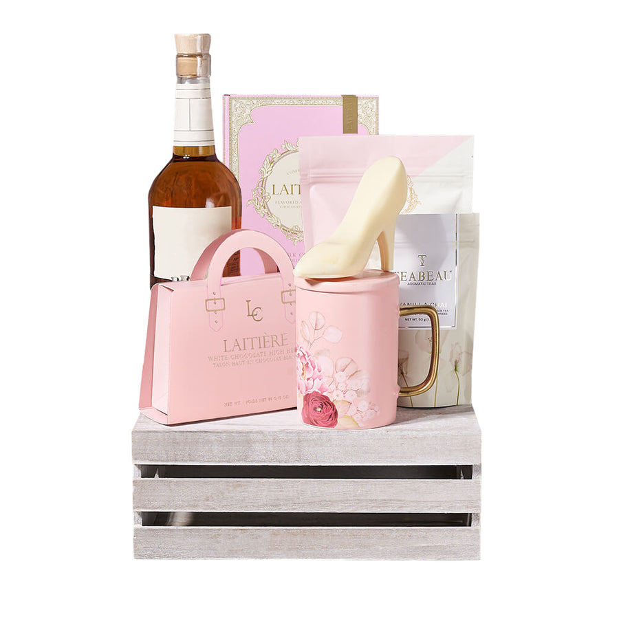 Liquor & Perfect Pink Chocolate Crate, bottle of liquor, a box of chocolate bars, white chocolate chip pink velvet cookies, white chocolate high heels, vanilla chai, and an adorable pink floral mug—all thoughtfully arranged in a wooden gift crate, Gift Sets from Blooms Canada - Same Day Canada Delivery.