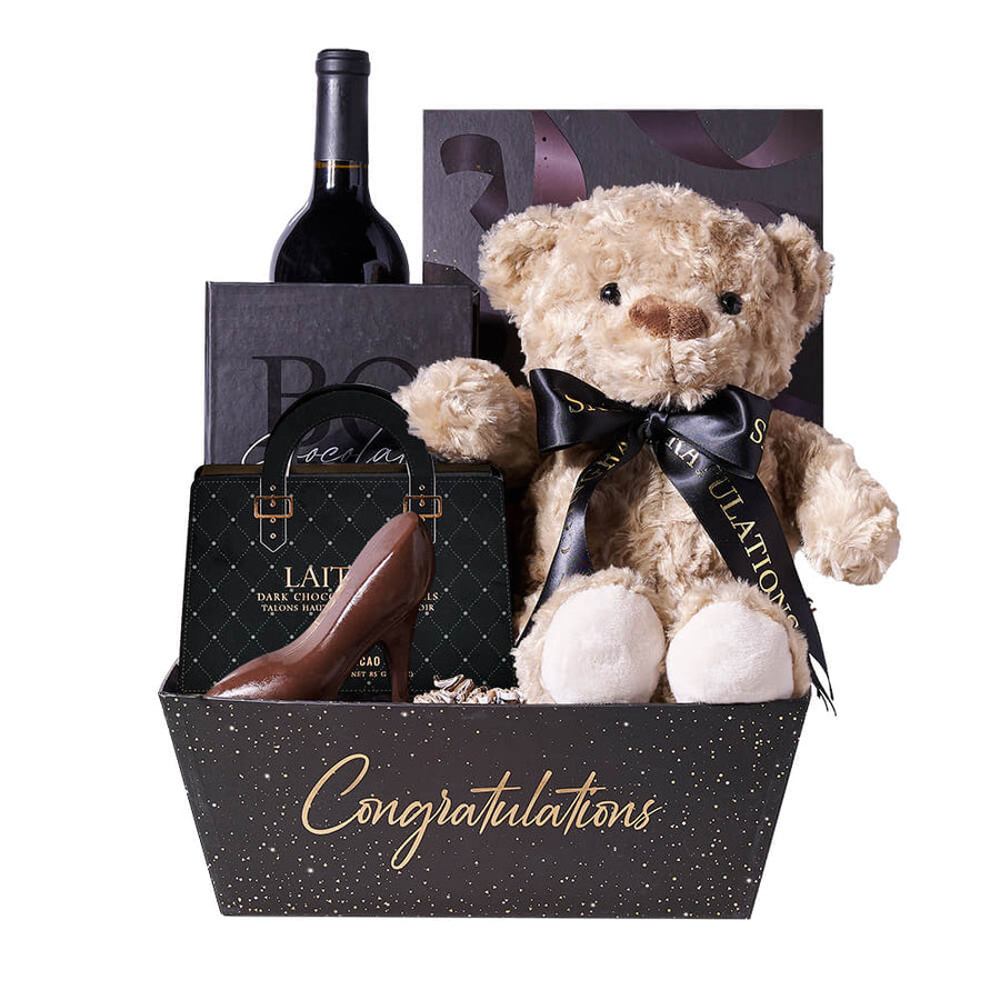 Bear & Wine Graduation Gift, bottle of wine, a plush teddy bear, a box of champagne-inspired chocolate truffles, dark chocolate high heels, a box of chocolate bars, and a Congratulations gift tray, Graduation Gifts from Blooms Canada - Same Day Canada Delivery.