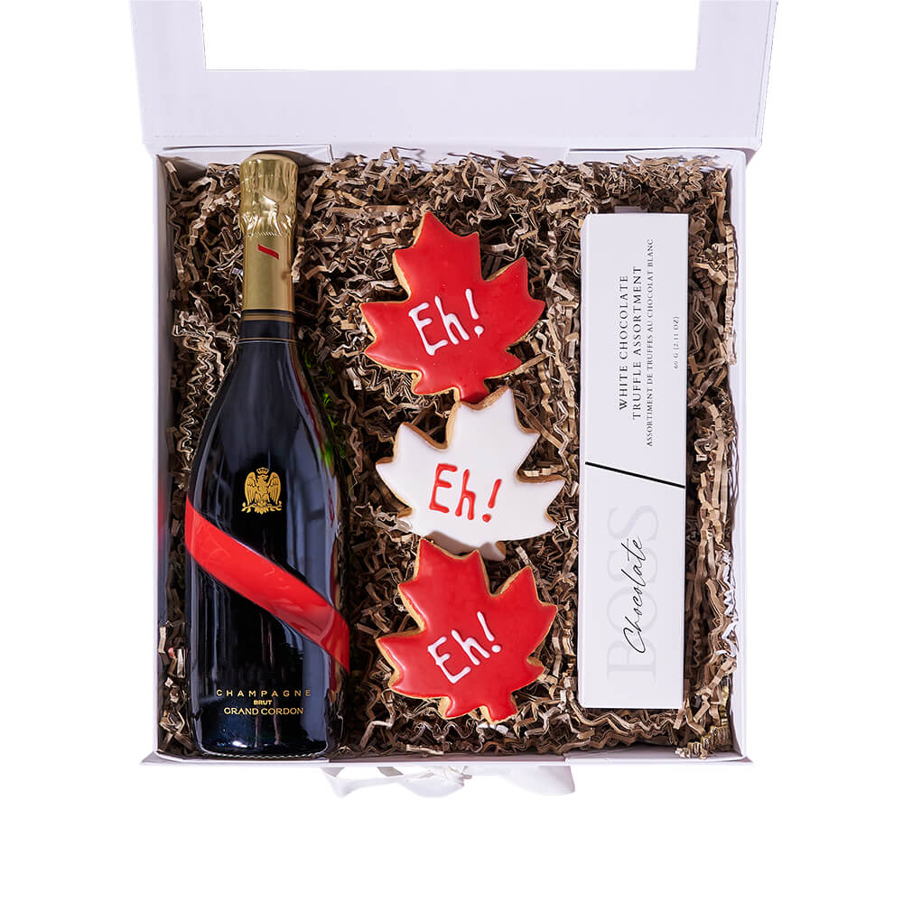 Canada Day Bubbly Box, bottle of sparkling wine, three Canada Day maple leaf-shaped cookies, assorted white chocolate truffles, all presented in a white gift box, Gift sets from Canada Blooms - Same Day Canada Delivery.