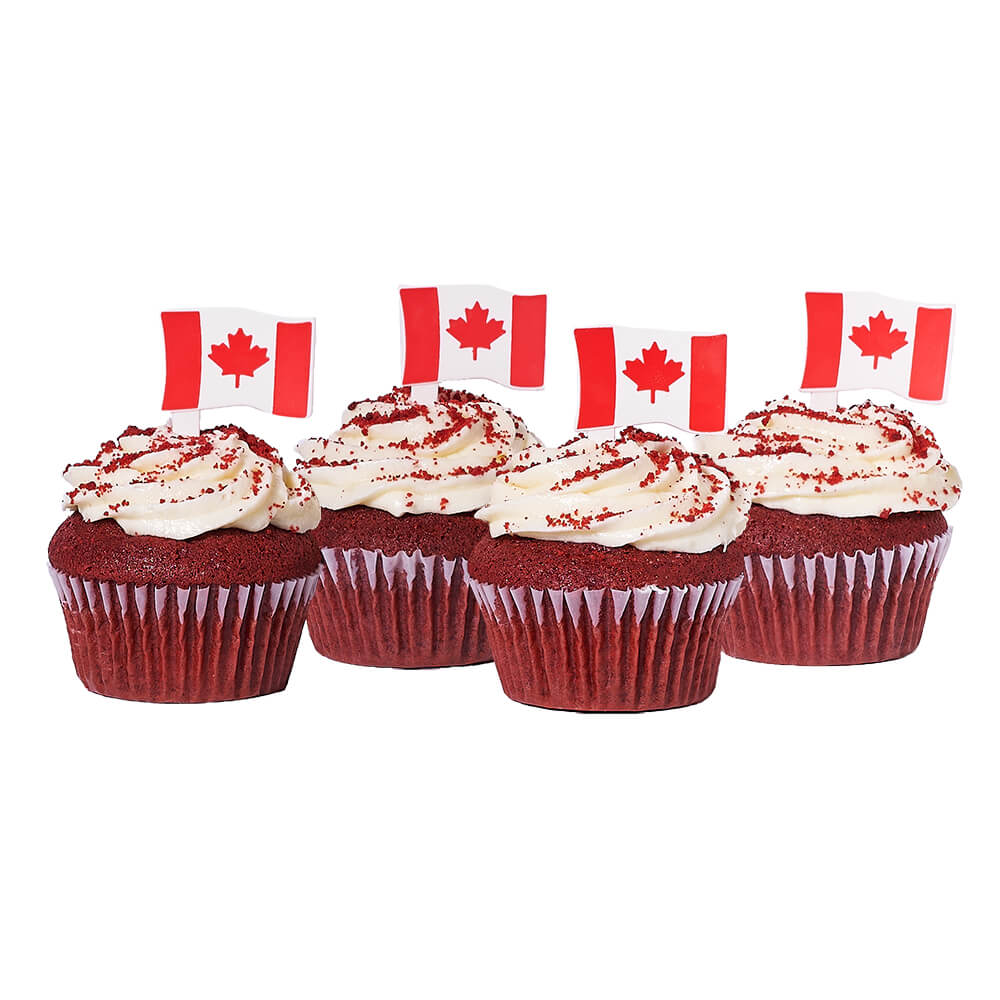 Canada Day Red Velvet Cupcakes, four perfectly baked red velvet cupcakes topped with smooth cream cheese frosting and charming Canadian flag decorations, Baked Goods from Canada Blooms - Same Day Canada Delivery.
