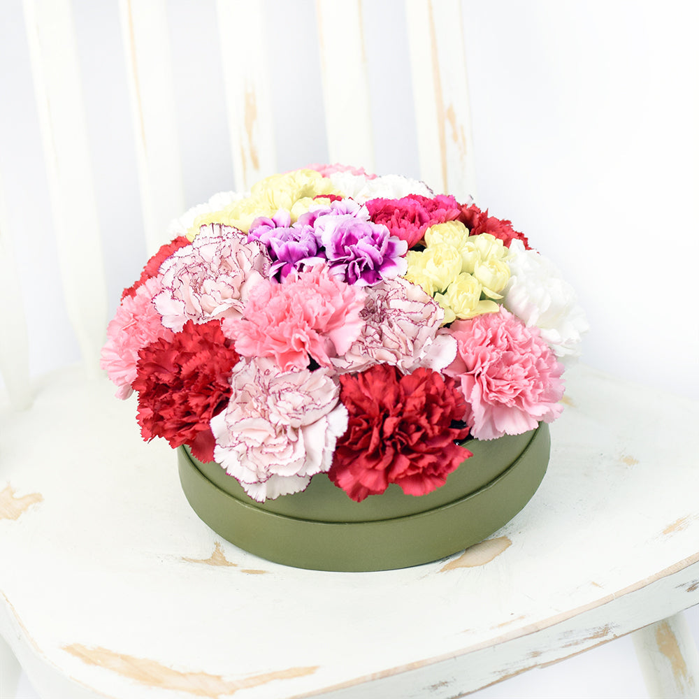 Colourful Radiance Flower Box Set, Brimming with carnations in rare and unique hues, Lovely selection of mixed carnations and ruscus in a short green designer hat box, Flower Gifts from Canada Blooms - Same Day Canada Delivery.