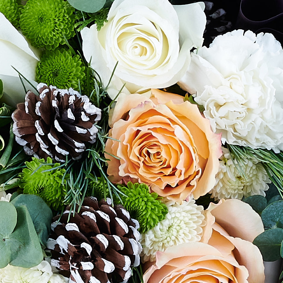 Elegant Winter Mixed Bouquet, roses, chrysanthemums, pine cones, and greens gathered in a floral wrap and tied with designer ribbon, Flower gifts from Canada Blooms - Canada Delivery