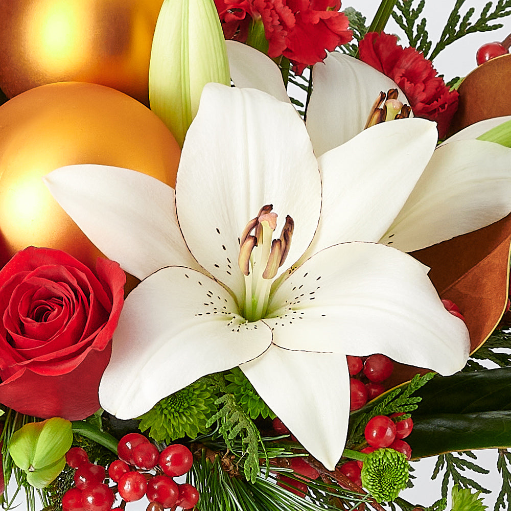 Joyous Christmas Floral Arrangement, roses, lilies, chrysanthemums, berries, greenery, pine cones, ornaments, and a Christmas decoration all arranged artfully into a ceramic pot, Flower Gifts from Canada Blooms - Canada Delivery