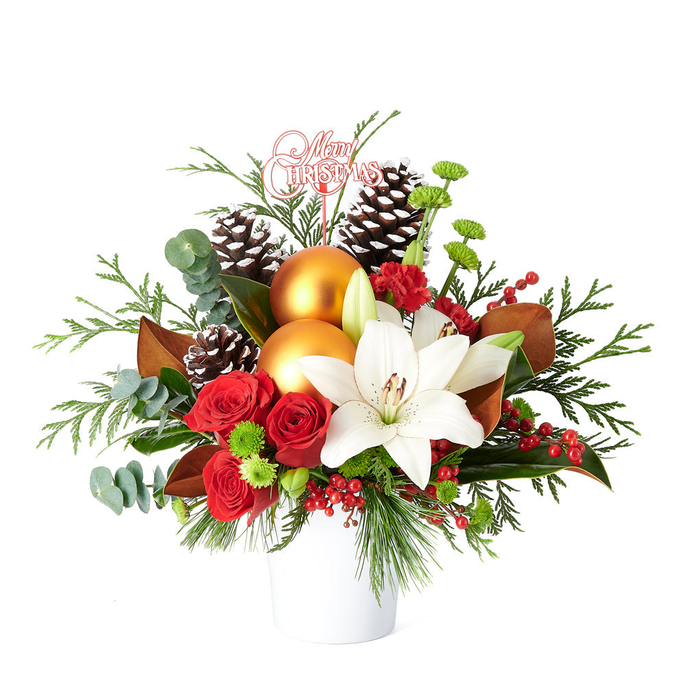 Joyous Christmas Floral Arrangement, roses, lilies, chrysanthemums, berries, greenery, pine cones, ornaments, and a Christmas decoration all arranged artfully into a ceramic pot, Flower Gifts from Canada Blooms - Canada Delivery