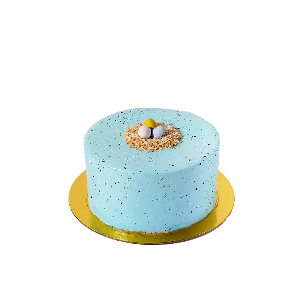 Easter Cake, scrumptious vanilla layer cake comes adorned with smooth buttercream frosting and features an adorable coconut nest filled with candy Easter eggs on top, Cake Gifts from Canada Blooms - Canada Delivery