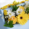 Yellow and white mixed floral arrangement in a blue toolbox. Same Day Blooms Canada Delivery