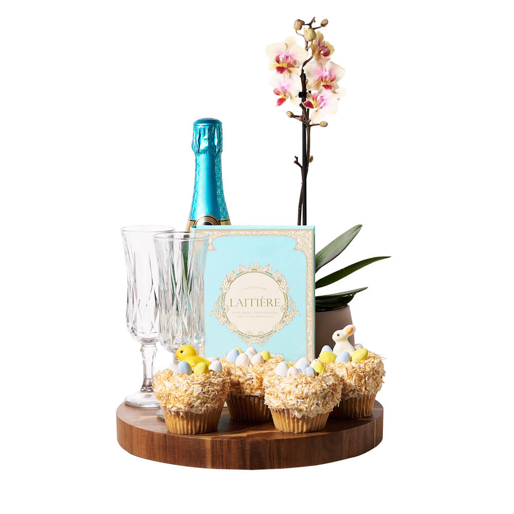 Bubbly Easter Orchid Gift, beautiful potted orchid, a bottle of fine sparkling wine, two champagne flutes, a box of chocolate bars, four of our delectable Easter cupcakes, and a round wooden cutting board, Easter Gifts from Canada Blooms - Same Day Canada Delivery.