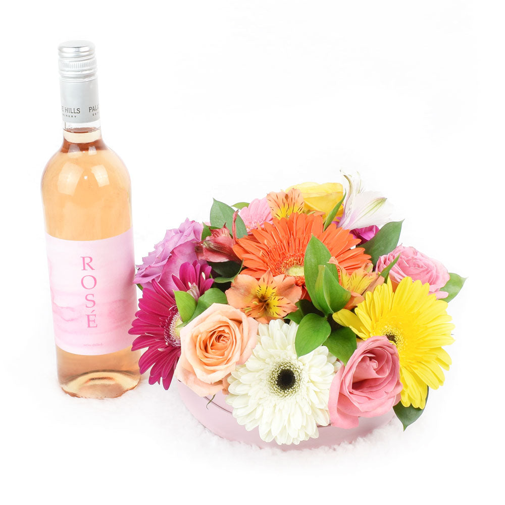 Celebrating Her Flowers & Wine Gift, roses, gerbera, alstroemeria and ruscus in a short pink designer hat box, bottle of red wine, Flower Gifts from Canada Blooms - Same Day Canada Delivery.