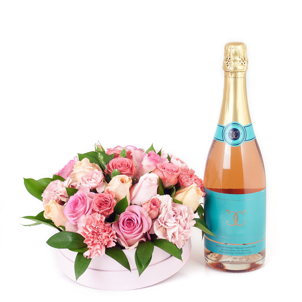 Simple Celebration Flowers & Champagne Gift, carnations, roses, spray roses, mini carnations, and greens in a short round pink hat box, a bottle of Sparkling Wine, Flower Gifts from Canada Blooms - Canada Delivery
