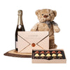 Champagne & Teddy Chocolate Gift, bottle of sparkling wine, a love letter box of chocolate truffles, a plush teddy bear toy, and a live-edge serving board, Champagne Gifts from Blooms Canada - Same Day Canada Delivery.