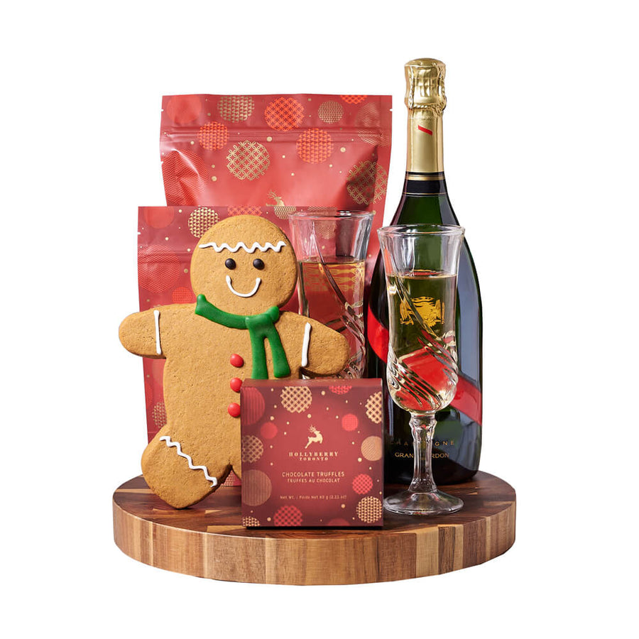 Gingerbread Man & Holiday Champagne Gift, bottle of sparkling wine, a beautiful pair of champagne flutes, a hand-decorated gingerbread cookie, chocolate truffles, white chocolate cranberry pistachio bark, white chocolate peppermint popcorn, and an end-grain cutting board for serving, Holiday gifts from Blooms Canada - Same Day Canada Delivery.